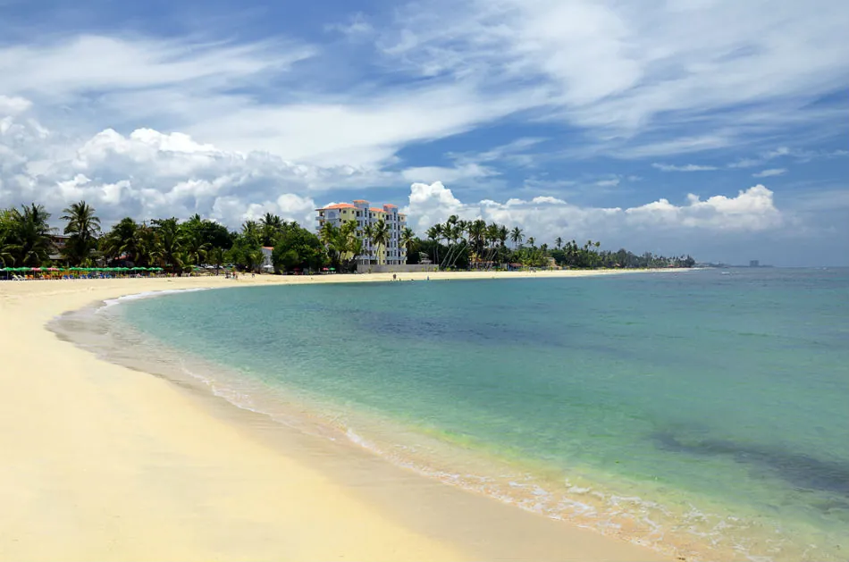 Juan Dolio beach with light sand and palm trees